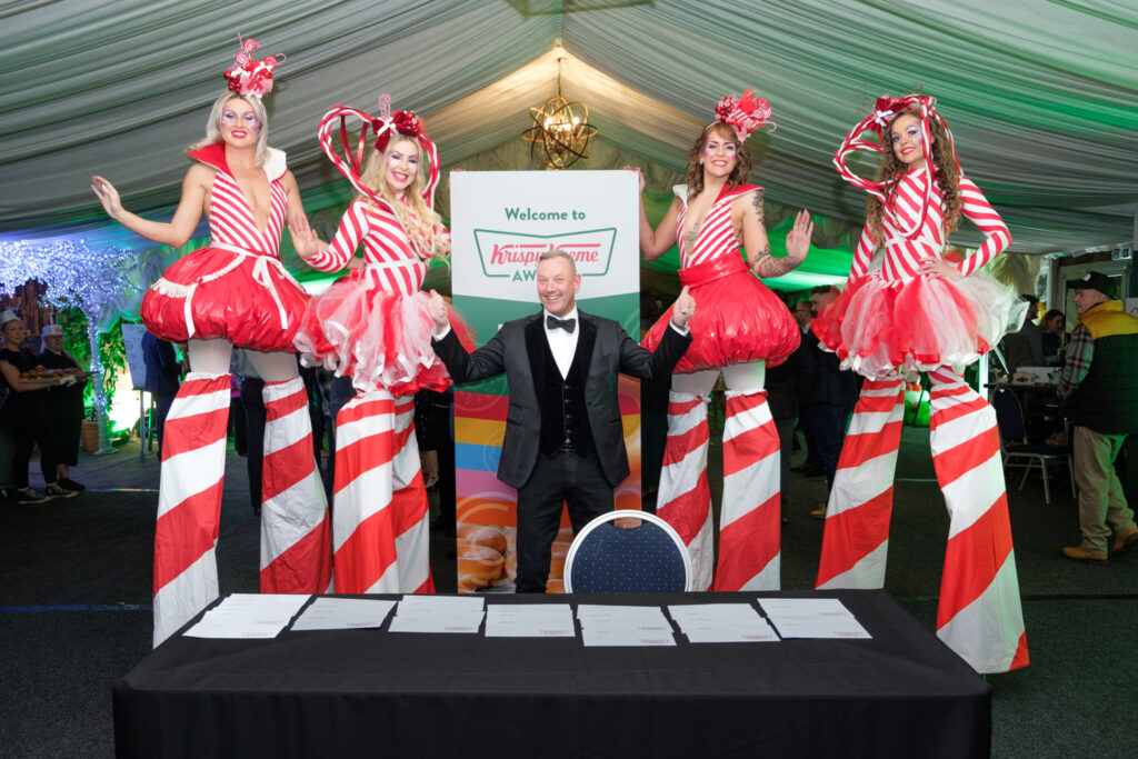 Area51's candy cane themed stilt walkers group photo for Krispy Kreme conference at the Heart of England Conference & Events centre.
